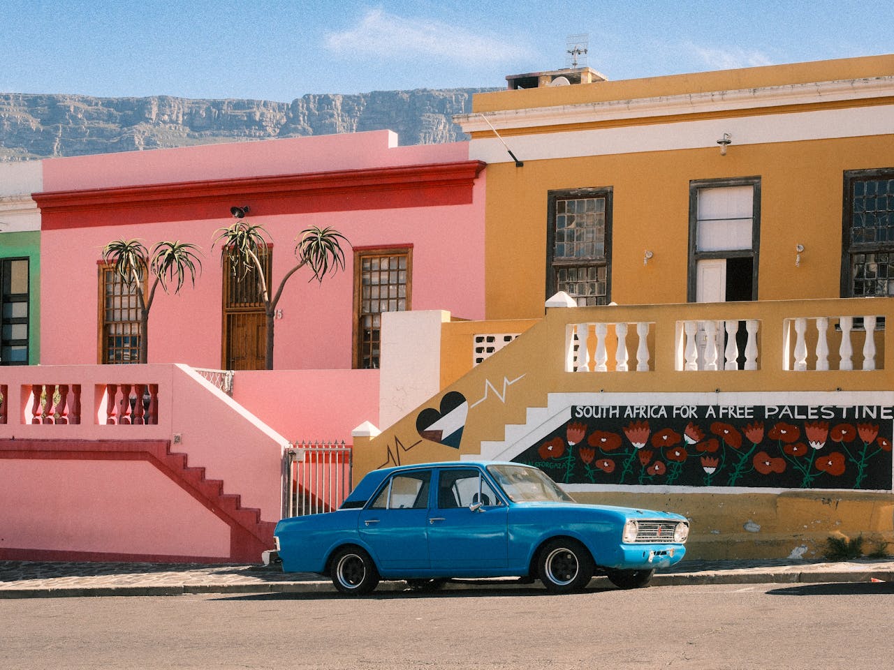 Mastering the First Impression: Your intriguing post title goes here Vibrant Bo-Kaap neighborhood with colorful houses and classic car in Cape Town, South Africa.