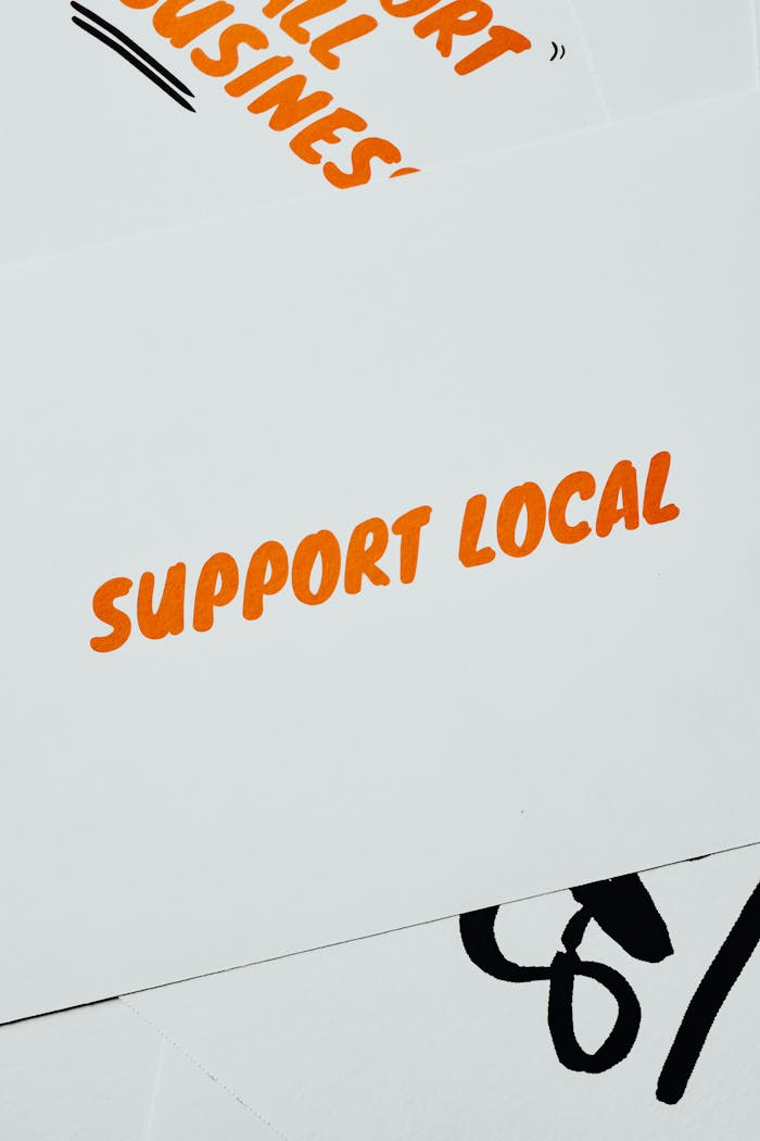 services-bg A minimalist card displaying 'Support Local' in bold orange text on a white background, promoting small businesses.