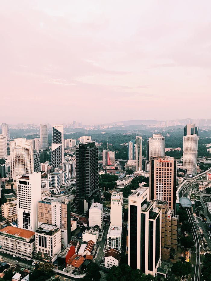 who-we-are Stunning aerial view of Kuala Lumpur's modern skyline with towering skyscrapers and cityscape at dusk.